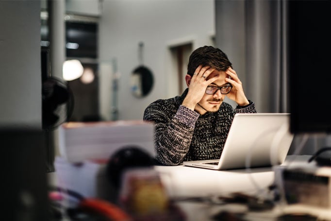 Man looking stressed at his computer