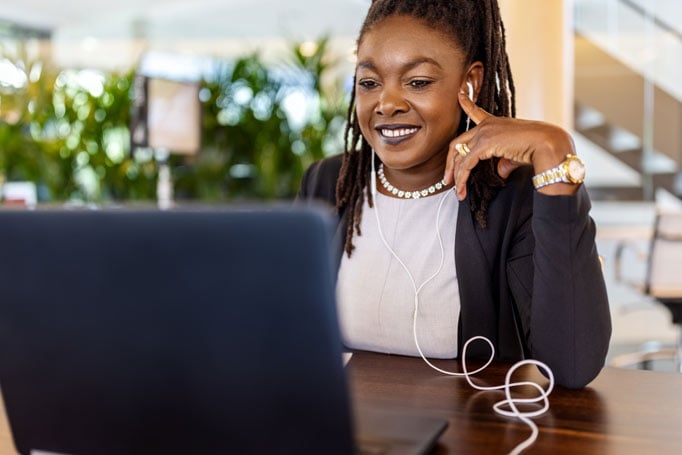 Woman smiles at her laptop