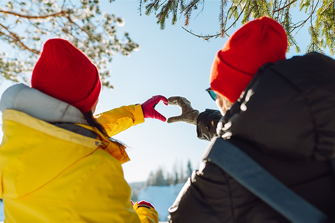 Two people making hand hearts