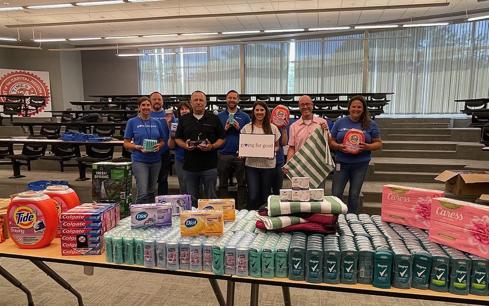 Volunteers standing together around supplies.